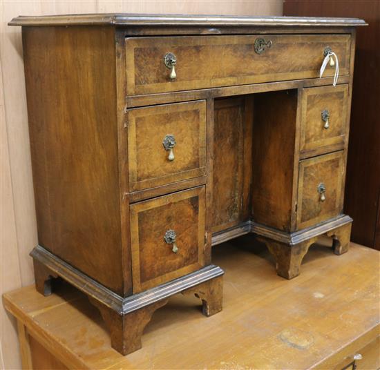 A Georgian style banded walnut kneehole desk W.87cm